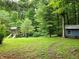Backyard with trees, playset, and shed at 8310 Dog Trot Ln, Morgantown, IN 46160