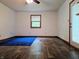 Bedroom featuring a window, door and blue rug at 8310 Dog Trot Ln, Morgantown, IN 46160