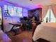 Bedroom featuring large screen TV, desk, and wood furniture at 8310 Dog Trot Ln, Morgantown, IN 46160