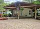 Inviting covered porch with hanging swing, decorative wreaths, and outdoor seating at 8310 Dog Trot Ln, Morgantown, IN 46160