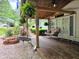 Comfortable covered porch featuring hanging plants, seating, and decorative accents at 8310 Dog Trot Ln, Morgantown, IN 46160