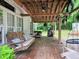Spacious covered porch with hanging swing, grill, and outdoor seating area at 8310 Dog Trot Ln, Morgantown, IN 46160
