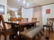 Inviting dining area with a wooden table, bench seating, and wood flooring at 8310 Dog Trot Ln, Morgantown, IN 46160