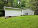 Low angle view of home exterior with siding and grass lawn at 8310 Dog Trot Ln, Morgantown, IN 46160