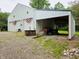 Detached garage featuring two garage doors and an open storage area at 8310 Dog Trot Ln, Morgantown, IN 46160