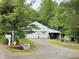 Detached two-car garage with white exterior, located on large gravel driveway at 8310 Dog Trot Ln, Morgantown, IN 46160