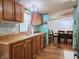 Kitchen with warm wood cabinets, stainless appliances, and view of dining area at 8310 Dog Trot Ln, Morgantown, IN 46160