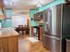Kitchen area features stainless steel appliances and adjacent dining area at 8310 Dog Trot Ln, Morgantown, IN 46160