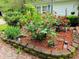 Beautiful rose bushes and flower beds enhancing the appeal of this lovely landscaped home at 8310 Dog Trot Ln, Morgantown, IN 46160