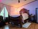 Main bedroom with ornate wood frame bed and neutral decor at 8310 Dog Trot Ln, Morgantown, IN 46160