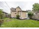 Exterior view of the house displaying the yard space and side door access at 839 N Oxford St, Indianapolis, IN 46201