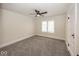 Comfortable bedroom with neutral walls, carpet, ceiling fan and a bright window for natural light at 839 N Oxford St, Indianapolis, IN 46201