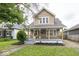 Charming home featuring a cozy front porch, well-maintained lawn, and attractive landscaping at 839 N Oxford St, Indianapolis, IN 46201