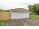 Detached two car garage with a white garage door and concrete driveway at 839 N Oxford St, Indianapolis, IN 46201