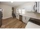 Well-lit kitchen featuring stainless appliances, white cabinets, and hardwood floors at 839 N Oxford St, Indianapolis, IN 46201
