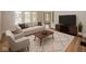 Bright living room features stylish furniture, wood floors, and a large window at 839 N Oxford St, Indianapolis, IN 46201