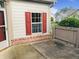 A home exterior with red door and shutter accents, complemented by brick and landscaping at 855 Gazebo Way # C, Greenwood, IN 46142