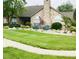 Beautiful clubhouse exterior featuring a stone facade, well-manicured lawn, and an American flag at 855 Gazebo Way # C, Greenwood, IN 46142
