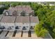 Aerial shot of townhome community featuring neat landscaping, varied exterior finishes, and private balconies at 9090 Demarest Dr, Fishers, IN 46038