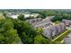 Aerial view of townhomes surrounded by trees, showcasing roof styles and community planning at 9090 Demarest Dr, Fishers, IN 46038