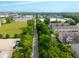A real estate aerial photo of townhomes near businesses and green spaces, conveying a sense of community at 9090 Demarest Dr, Fishers, IN 46038