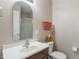 Neutral toned bathroom with a vanity, decorative mirror, and a shower with glass door at 9090 Demarest Dr, Fishers, IN 46038