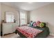 Cozy bedroom with a cherry-themed blanket and a comfortable full sized bed in front of a bright window at 9090 Demarest Dr, Fishers, IN 46038