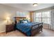 Comfortable bedroom with plush bedding, neutral walls, and a large window providing ample natural light at 9090 Demarest Dr, Fishers, IN 46038