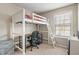 Bedroom featuring a lofted bed with a built-in desk area, creating a functional and modern space at 9090 Demarest Dr, Fishers, IN 46038
