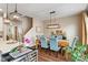 Elegant dining room adjacent to kitchen with modern lighting and comfortable seating for Gathering gatherings at 9090 Demarest Dr, Fishers, IN 46038