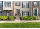 Attractive townhome exterior with tasteful landscaping and a welcoming entrance, complete with wreath at 9090 Demarest Dr, Fishers, IN 46038