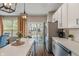 Bright kitchen with stainless steel appliances, white subway tile backsplash, and views of the backyard at 9090 Demarest Dr, Fishers, IN 46038