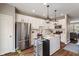 Stylish kitchen featuring stainless steel appliances, a wine cooler, and a functional island with pendant lighting at 9090 Demarest Dr, Fishers, IN 46038