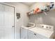 Efficient laundry room with modern washer, dryer, and convenient shelving for storage solutions at 9090 Demarest Dr, Fishers, IN 46038