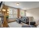 Cozy living room with a comfortable sofa, ottoman, and large window offering plenty of natural light at 9090 Demarest Dr, Fishers, IN 46038