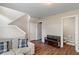 Inviting basement area with a comfy couch, wooden bench, and adjacent powder room at 9090 Demarest Dr, Fishers, IN 46038