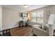 Comfortable living area featuring a workspace, modern furniture, and natural light from the window at 9090 Demarest Dr, Fishers, IN 46038