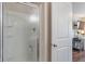 This glass shower door is located next to the doorway to a room that features a work area at 9090 Demarest Dr, Fishers, IN 46038