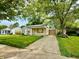 Charming single-story home featuring a well-manicured lawn and attached garage at 910 Lonsvale Dr, Anderson, IN 46013