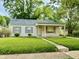Quaint single-story home with a covered front porch and well-maintained landscaping at 910 Lonsvale Dr, Anderson, IN 46013