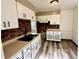 Functional kitchen featuring white cabinets, black hardware, and a brick backsplash at 910 Lonsvale Dr, Anderson, IN 46013