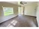 Bright living room with a large window, neutral carpet, and a view of the front yard at 910 Lonsvale Dr, Anderson, IN 46013