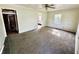 Spacious living room with neutral carpeting, a ceiling fan, and ample natural light at 910 Lonsvale Dr, Anderson, IN 46013