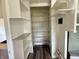 Walk-in pantry features extensive built-in shelving and laminate flooring at 910 Lonsvale Dr, Anderson, IN 46013