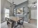 Bright dining room boasts a stylish chandelier, bench seating and a view to the kitchen at 933 Curlew Ln, Greenwood, IN 46143