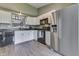 Modern kitchen with white cabinets, black countertops, and stainless steel appliances at 933 Curlew Ln, Greenwood, IN 46143