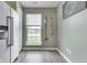Bright kitchen area features a stainless steel refrigerator, and a window view of the outdoors at 933 Curlew Ln, Greenwood, IN 46143