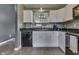 Stylish kitchen with white cabinetry, black countertops, and a view through to the dining area at 933 Curlew Ln, Greenwood, IN 46143