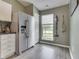 Bright kitchen area with stainless steel refrigerator, and a window offering a view of the outdoors at 933 Curlew Ln, Greenwood, IN 46143