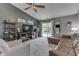 Bright living room with vaulted ceilings, ceiling fan, a brown sectional, and a sliding glass door at 933 Curlew Ln, Greenwood, IN 46143